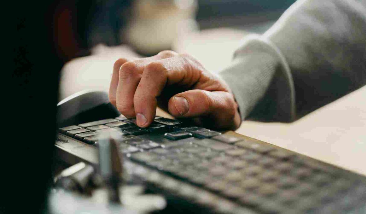 Man writing on computer keyboard. IT Service Management