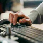 Man writing on computer keyboard. IT Service Management